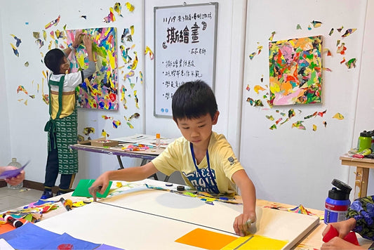 Children participating in a tape-based creative practice, removing and reapplying materials to transform the artwork and space.